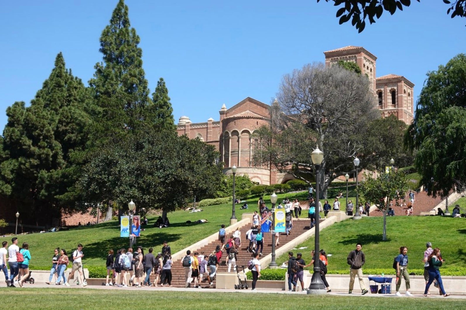 Students walk up and down an outdoor staircase.